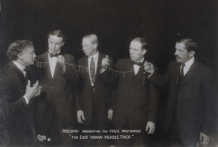 To the apparent astonishment of onlookers in this carefully staged photograph, circa 1915, Houdini demonstrates his famous Needle Threading Trick. Courtesy of Ken Trombly, Bethesda, Md. ⁄ean A. Beasom photo