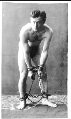 Houdini struck this classic pose, manacled hand and foot, about 1906, when he had gained international fame as "The Handcuff King.†Courtesy of Library of Congress, Rare Book and Special Collections.