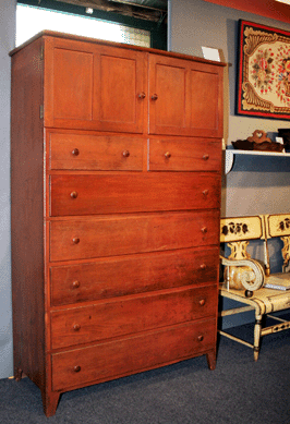 Courcier & Wilkins, Yarmouth, Mass., used the pass-through in its booth to creatively display the backside, dated 1853, on the New Lebanon, N.Y., Shaker double cupboard over drawers.