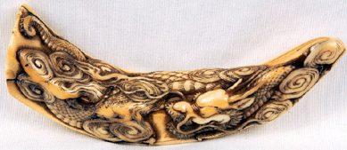 A 4-inch Nineteenth Century warthog tusk carved with a dragon design brought $26,450.