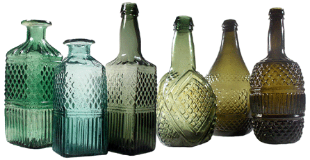 The blown three-mold decanters with geometric decoration were made in a range of soft green colors at Keene in the 1820s. The three on the left are rare square examples. Decanters were made with or without flanges, but most were not meant to have stoppers. †John W. Hession photo