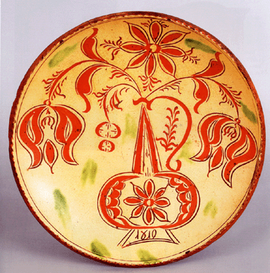 A sgraffito decorated redware charger dated 1810, Hancock Township, Penn., attributed to Conrad Mumbouer, 12 inches in diameter, carried an estimate of $30/40,000 and sold for $52,140.