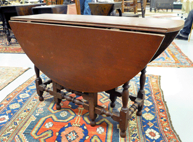 The William and Mary gate leg table in pleasing old red paint sold at $31,625.