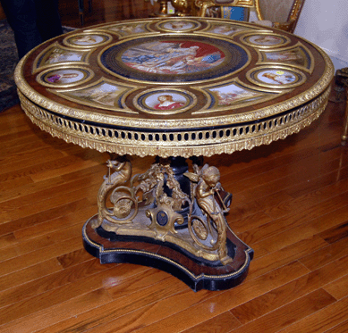 A Twentieth Century Napoleon III-style rosewood center table with a central Sevres-style plaque depicting Louis XVI surrounded by other plaques depicting ladies of the court brought $31,050.