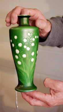 A Tiffany glass vase in spring green, sprightly with white dots, sold on the phone for $5,900.