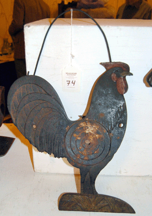 The auctioneer's prized cast iron rooster form shooting gallery target brought $9,360. Will Henry acquired it as a youngster and pedaled it home on his Schwinn †it has traveled with him ever since.