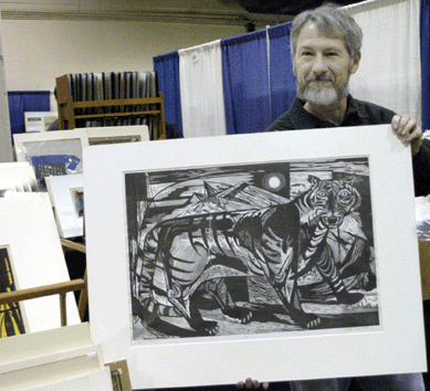 Marc Chabot of Marc Chabot Fine Arts, Southbury, Conn., holds up a striking and graphic drawing, "Tiger,†by Misch Kohn and dated 1949. This very large wood engraving was pulled from the block and is from an edition of 30.