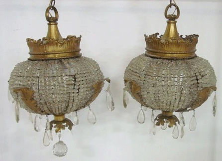 This pair of antique French bronze and beaded crystal chandeliers with leaf design, 25 inches high and 18 inches diameter, was stolen. A reward is being offered for information leading their recovery.
