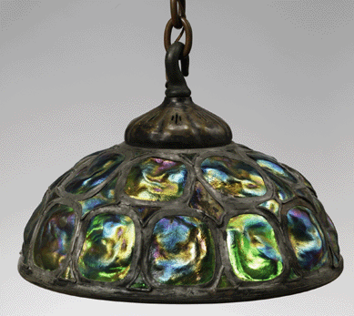 A turtleback hanging shade by Tiffany Studios, circa 1905, constructed of cast and leaded glass, bronze, 13 by 18 inches diameter. ⁊oseph Coscia Jr photo