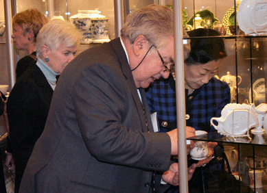 English pottery specialist Gary Atkins of London opens a case for Deanne Levison and Lulu Wang, left and right. Milly McGehee is at left rear.