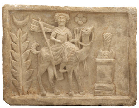 The Palmyrene god Arsu is depicted riding a camel on a limestone panel from the Temple of Adonis.