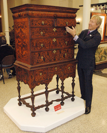 Leigh Keno stands with the top furniture lot of the sale, the William and Mary veneered high chest of drawers that brought $317,200, well above the high estimate of $120,000. It is of Boston origin and dates circa 1705‱725. It is in two sections and measures 68 inches high.