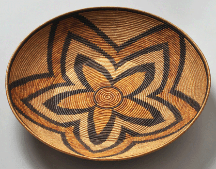 This Mission Indian basket, probably created by a Luiseno in Southern California in the late Nineteenth to early Twentieth Century, owes its grand central design to a combination of coiled sumac, natural juncus and black-dyed juncus on a deer grass bundle foundation. ⁓usan Einstein photo