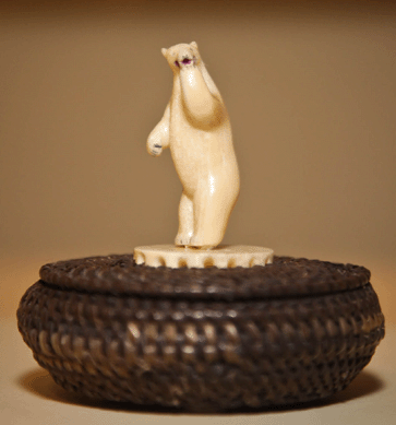 Many exhibition visitors are drawn to Inupiaq whale baleen baskets topped by ivory carvings. This playful polar bear lidded basket was created around 1949. ⁁bel Gutierrez photo