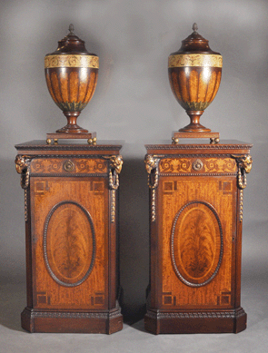 A pair of carved mahogany Adams-style urns and a pair of custom mahogany cabinets (not shown) brought $8,050.