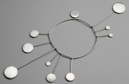 Betty Cooke's circa 1965 celestial necklace makes use of repeated circles suggestive of the sun and the moon. ©1969 Betty Cooke. Photograph ©Museum of Fine Arts, Boston. Image courtesy Museum of Fine Arts, Boston, the Daphne Farago Collection.