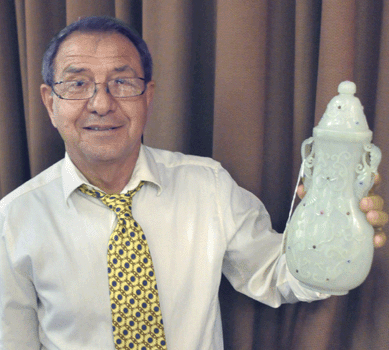 Leslie Baker with the top lot of jade from the auction, a carved translucent white jade vase with foliate pierced handles and inset cabochons. Signed with a four character Qianlong mark, it sold for $28,320.