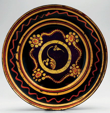 The trailing on this dish made between 1775 and 1795 in Almance County, N.C., has parallels in painted decoration on chests attributed to Berks County, Penn., where members of several Almance County families originally settled. Motifs occurring in both groups of objects include stems with jeweled edges, awkwardly perched birds and both abstract and naturalistic plant forms. Lead-glazed earthenware, diameter 15½ inches. Old Salem Museums & Gardens. 