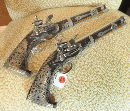 The pair of Miquelet locks pistols, Spanish, circa 1775, with elaborate silver overlay and engraving sold for $34,500.