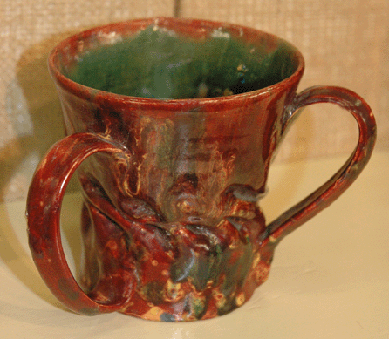 This George Ohr three-handled cup was a spectacular late example of the "Mad Potter of Biloxi's†work, with a rarely seen red glaze mottling. The cup was on view at Rago Arts & Auction Center, Lambertville, N.J.