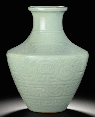A celadon-glazed carved baluster vase Qianlong seal mark in underglaze blue and of the period (1736‱795) brought $7,922,500 (world auction record for Qing monochrome porcelain).