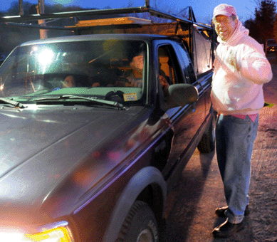 Elephant's Trunk proprietor Greg Baecker lets dealers onto the field during the predawn hours.