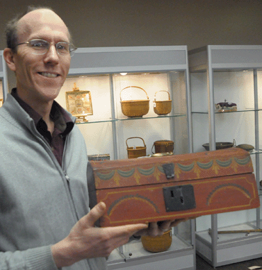 Fairfield Auction's Jack DeStories with the paint decorated dome top box attributed to a Worcester, Mass., maker. The lot was the subject of active bidding, selling in the room for $16,100.