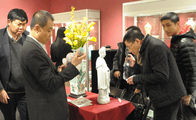 Clients looking over pieces at Imperial Oriental Art during preview.