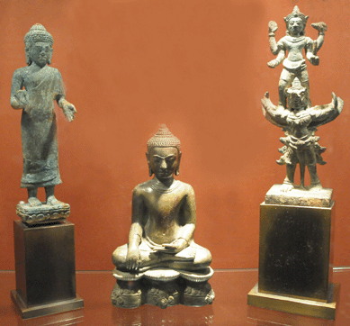 The Lopburi, Bayon Thirteenth Century bronze Buddha in original patina, center, was described as "unparalleled,†at Buddhist Art, Berlin, Germany. Also displayed were Tenth Century, left, and a Twelfth Century Buddha from Khmer, Banyon.