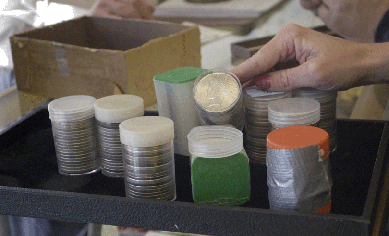 This set of 200 mixed American silver dollars and other coins sold to the room for $5,750.