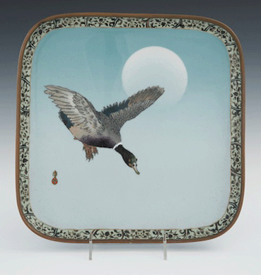 A cloisonné and musen tray displaying a mallard duck in flight, signed by Dai Nihon Nagoya Takeuchi, sold above estimate for $7,590. 