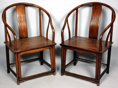 A Seventeenth or Eighteenth Century pair huanghuali wood horseshoe chairs brought $87,400. 
