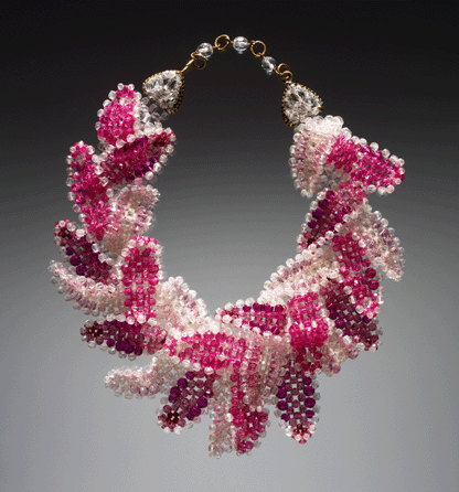 Designers in the 1960s sought out materials unusual for high fashion to appeal to a youthful, adventurous clientele. The Italian firm Coppola e Toppo combined gold-plated metal crystals and opal set on a network of plastic stones in festoon necklaces made for the Pucci label. Measuring 11 by 11 inches, this necklace added a vivid splash of color to the wearer's attire. Courtesy of D. Swarovski & Company.