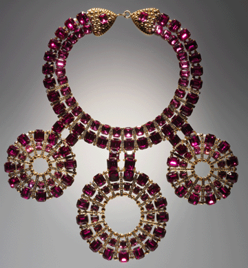 The so-called "beautiful people†in the jet-setting 1960s and 1970s favored slinky silk jersey and polyester, embellished with all manner of baubles and sequins, such as this necklace with three circular pendants. Designed by Coppola e Toppo for Valentino in 1970, it added glitter and glamour to any ensemble. Courtesy of D. Swarovski & Company. 