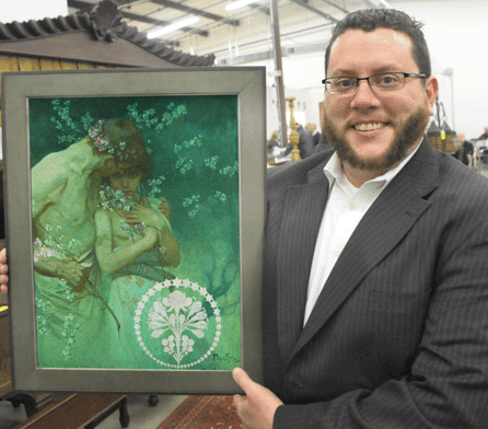 Auctioneer Ryan Brechlin with the Alphonse Mucha painting that sold for $57,500. ⁄avid S. Smith photo