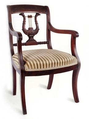 An open armchair (fauteuil) in the Federal manner in walnut with a lyre-form back terminating in carved eagle's heads and with brass "strings.†It is thought to have been made in New Orleans by master cabinetmaker Francois Seignouret in 1818. New Orleans Museum of Art.