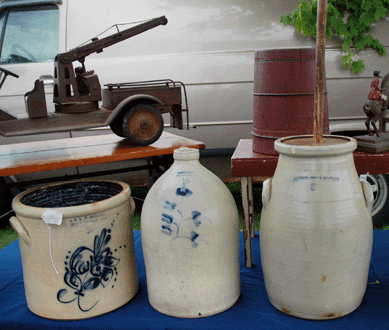 Among the notable stoneware offered by R. McGrory, East Falmouth, Mass., from left, an E&L Norton, Bennington, Vt., 3-gallon crock; a Julius Norton, Bennington, 2-gallon jug; and a Bangor Stoneware Co. 3-gallon churn, all circa 1800s. ⁂rimfield Acres North.