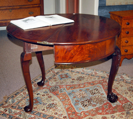 An Eighteenth Century Newport mahogany demilune card table realized $46,000 in the gallery.