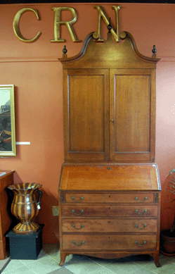An Eighteenth Century Kentucky Federal cherry secretary, circa 1795, that descended in the family of Judge Davis Edwards of Louisville sold for $40,250. The large English Regency treenware urn to the left brought $2,760.