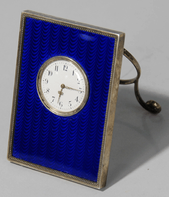 The silver and enamel desk clock by Twentieth Century Fabergé workmaster Henrik Immanuel Wigström brought $86,250.