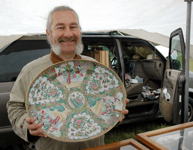 John Darrow shows a choice piece from his and his wife Dannette's collection of Rose Medallion. The Darrows are from Binghamton, N.Y.