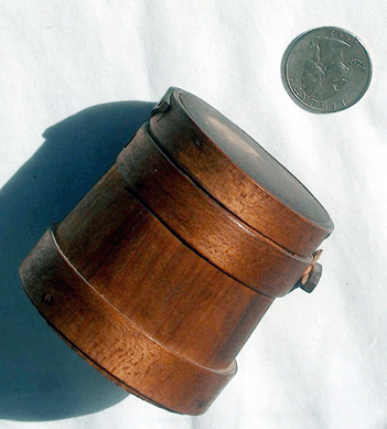 At Matt King's, Marshfield, Mass., this tiny firkin marked "Made in Hingham, Mass.†is pictured with a quarter to show how small it really is.