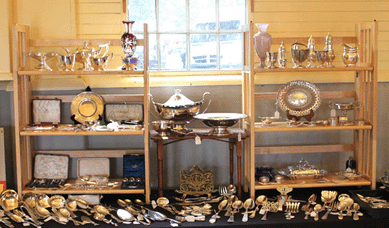 Set up in the basement of the barn, silver and china specialist Tom Copadis of Deering, N.H., sold copper molds, some pieces of glass, an opalescent vase and some of his specialty silver serving pieces. Copadis's business is named Peter Wood Hill Antiques.