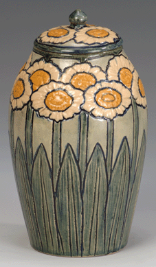 The 8-inch-tall earthenware jar was designed and executed by Harriet Coulter Joor and potted by Joseph Fortune Meyer in 1904 at the Newcomb Pottery in New Orleans, La.