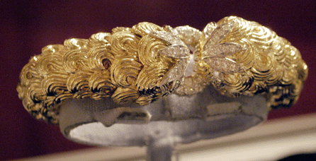 An 18K gold and platinum bracelet, mid-Twentieth Century, handmade with an intricate scalloped scrollwork, was catching attention at Brad Reh, Inc, Southampton, N.Y.