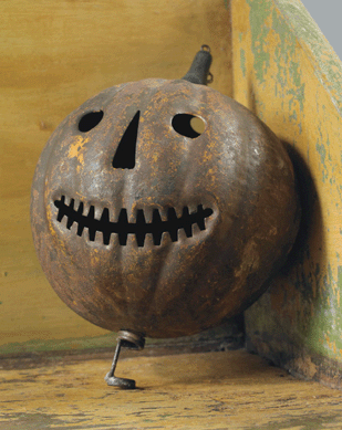 What starts well, ends well, can be said of this auction, as lot 720, an early molded and cut tin Halloween candle lantern in the form of a jack-o-lantern with traces of the original orange painted finish, late Nineteenth Century, 9½ inches high, sold for over ten times the high estimate at $9,440.