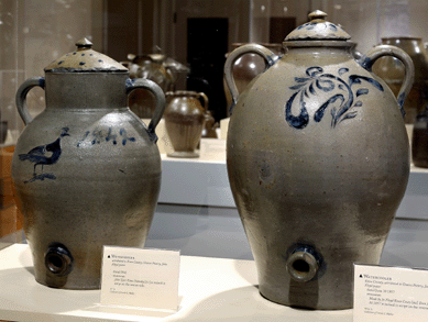 Two impressive water coolers that display New York or New Jersey characteristics with their stylized ovoid forms, vertical loop handles and incised decoration filled with cobalt. Both are attributed to the Graves Pottery, Knox County, John Floyd potter. The cooler on the left measures 17 inches tall and is incised with a peafowl on the front. The reverse has incised decoration partially obscured by a crudely drawn stickman hanging from the barrel of a rifle. "John Tyler Vetoes Noboddy [sic]†is incised in the area where the decoration was obscured. The cooler on the right is incised in script on the reverse shoulder: "Made by Jn Floyd Knox Couty [sic] Tenn June 30 1857.†