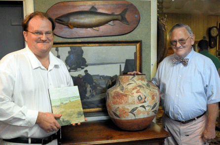 Josh Eldred, left, with the William Merritt Chase painting on panel, "Sailboats on Beach,†that sold for $126,500, and Bob Eldred with the Acoma olla that realized $34,500.