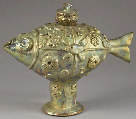 Meet the tea-fish, a rather practical creature from the mind of the artist. It is decorated a green-gold luster earthenware, circa 1983. Collection of Inge Peters, New York City. ⁎oel Allum photo, ©Beatrice Wood Center for the Arts/Happy Valley Foundation