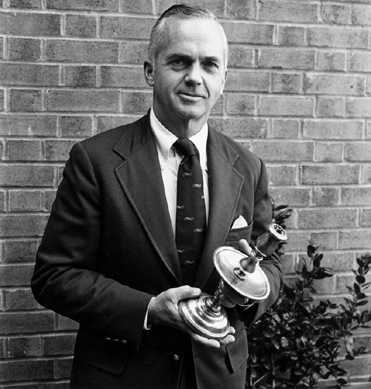 In earlier days, Val Jacobsen is shown with an antique candlestick.